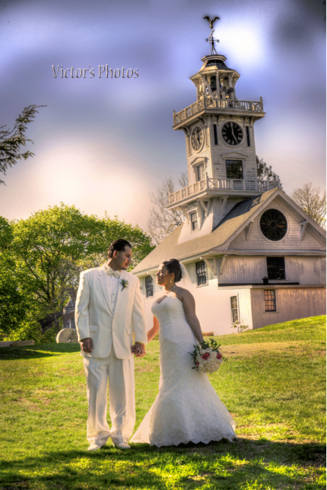 a bride and groom standing outdoors