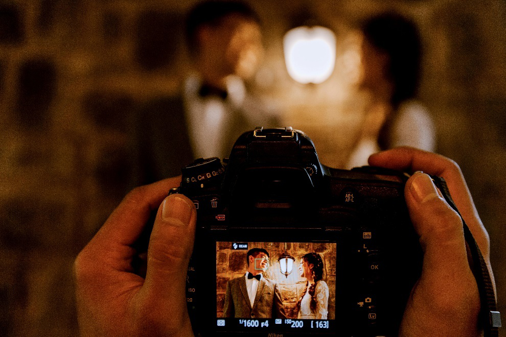 Photographer about to take a shot of a beautiful couple